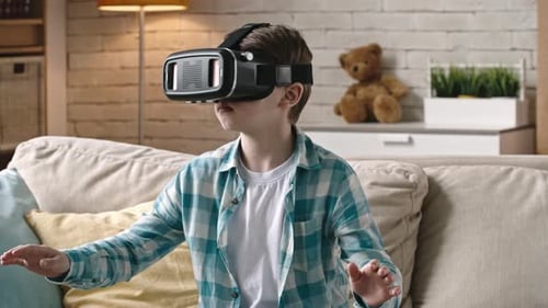 Child Wearing VR Headset Sitting on Couch