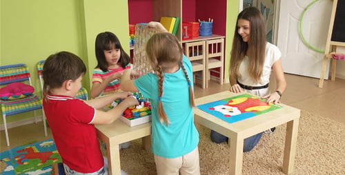 Children Play with Building Blocks in Bright Classroom