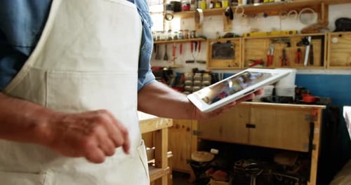 Man Using Tablet in Workshop