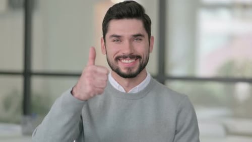 Young Man Gives Thumbs Up to the Camera