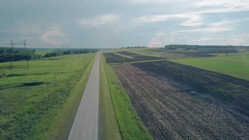 Bird Eye Flight Car Drives Along Gray Road Under Summer Sky