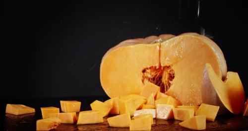 On Chopped Pieces of Ripe Pumpkin Falling Water Drops