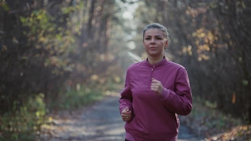 Closeup Slow Motion Video of a Caucasian Woman Running Around the Park