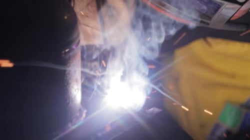 Welder Working with Intense Light and Sparks