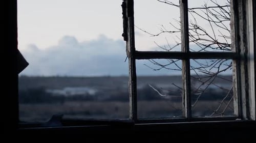 Silhouette Man in Dark Cloak with Hood on Head Against Sky Twilight Time