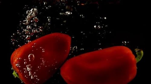 Red Bell Peppers Falling Into Water