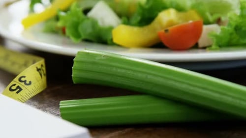 Fresh Salad with Measuring Tape and Blank Notebook