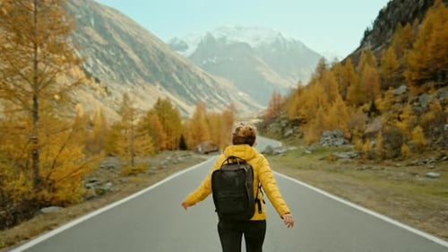 Woman Walking Road Through Beautiful Autumn Mountains