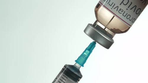 Drawing Coronavirus Vaccine into Syringe from Vial