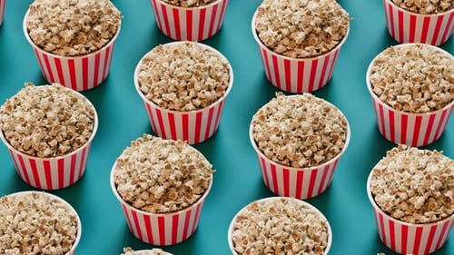 Seamless Looping Popcorn Cups Pattern on a Blue Background