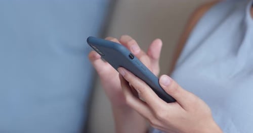 Close up Of Woman Use of Mobile Phone and Sit on Couch