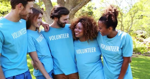Diverse Volunteers Smiling Together in Green Park