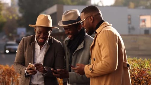Stylish Men Using Mobile Phones in City