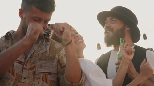 Friends Dancing and Smiling at Outdoor Gathering