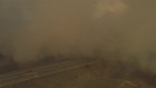 Wildfire Burns Through Rural Landscape Near Road