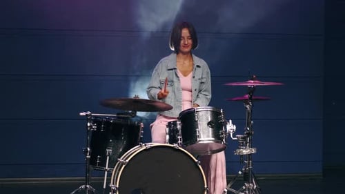Young Stylish Woman Is Playing Drums in Professional Music Studio