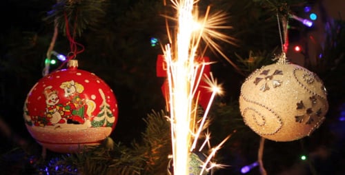 Sparkling Firework Candle Burns on Christmas Tree