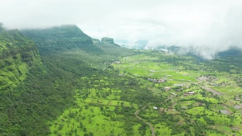 Top view of Village with rice paddy fields at base of the Mountain ranges of the Western Ghats