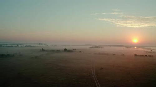 Aerial Drone View. Beautiful Misty Dawn in the Spring on the Lake. and Rural Road