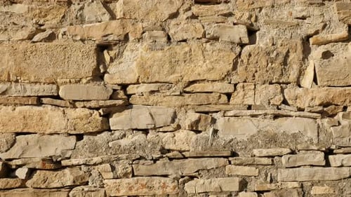 Close-up of ancient masonry construction 4K 2160p 30fps UltraHD tilting footage - Old house stone w