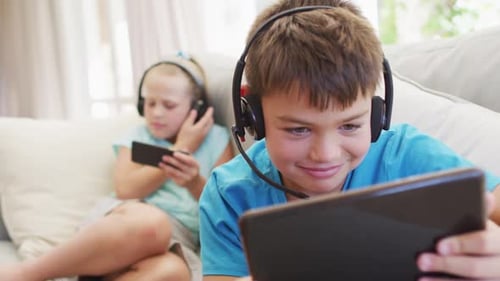 Children Using Technology on the Couch Indoors