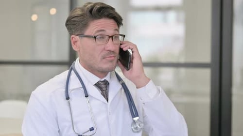 Doctor Talking on Phone in Office