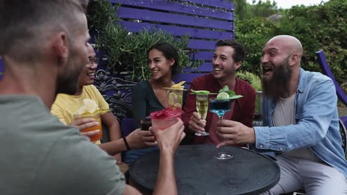 Friends Celebrate with Cocktails at an Outdoor Gathering