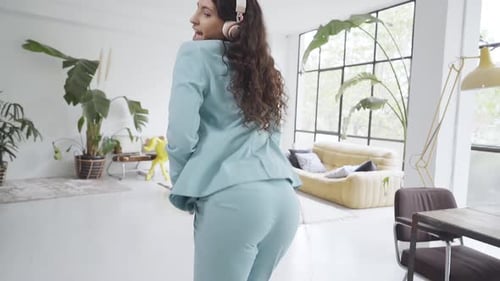 Young Business Woman Dances Her Ass Off in the Office Cheerful and Happy for a Job Well Done