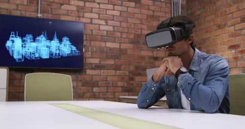 Creative businessman using virtual reality headset in modern office