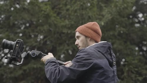 Cameraman filming with gimbal, close up shot