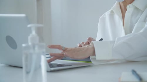 Designer Using Tablet and Laptop for Creative Work