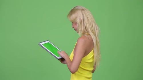 Woman Using Tablet With Green Screen Display