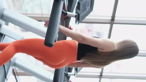 Woman Walks on Treadmill in Modern Gym