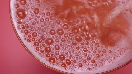 Closeup of Glass with Sparkling Rose Wine Decorated Gold Star Confetti Celebration Party