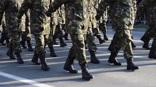 Soldiers Marching in Camouflage Uniforms on City Street