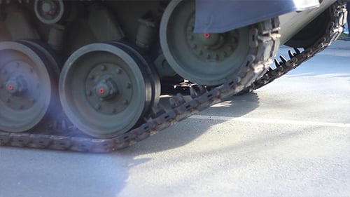 Military Tank with Treads Moving on Asphalt