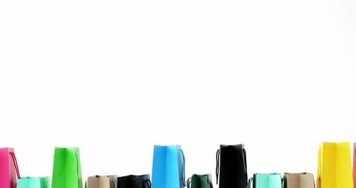 Colorful Shopping Bags Lined Up on White Background