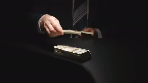 Bundles of Hundred Dollar Bills Being Counted