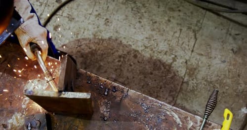 Male engineer using welding torch