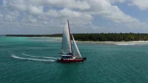 Aerial Footage of a Sailing Yacht in the Ocean with Light Blue Water Vacation