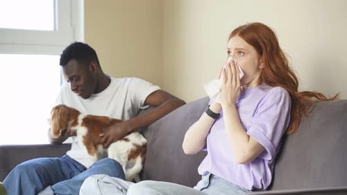 Young Woman with Allergies on a Couch with Friends