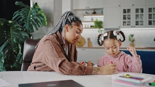 Young African American Mother and Daughter Drawing Picture Together at Home Tracking Shot Slow