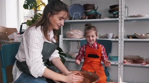 Ceramic Artist Teaching Kid How To Create Ceramics