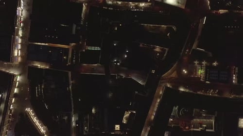 Top Down Panning Footage of Buildings and Illuminated Streets in Night City