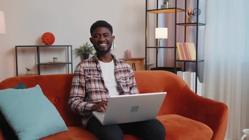 Man Working On Laptop In Cozy Home