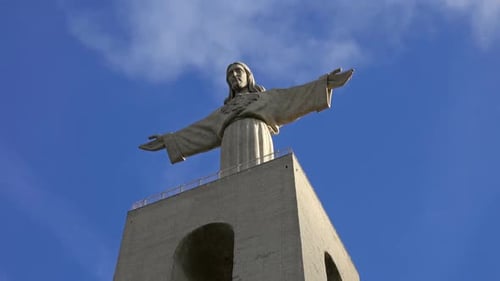 Christ King Statue Against a Blue Sky with Clouds