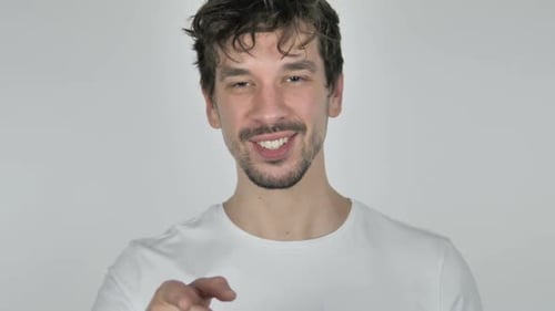 Smiling Man Points Directly at the Camera