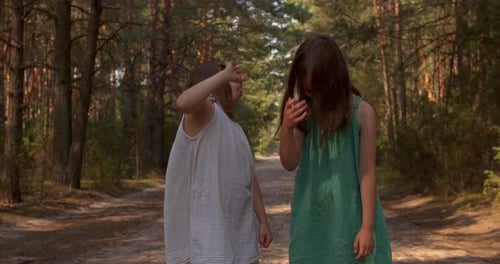 Two Beautiful Girls Walking in the Woods