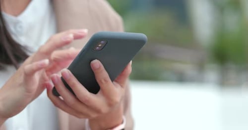 Woman Using Smartphone in Urban Setting Close Up
