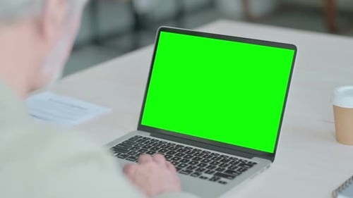Old Man Using Laptop with Green Screen